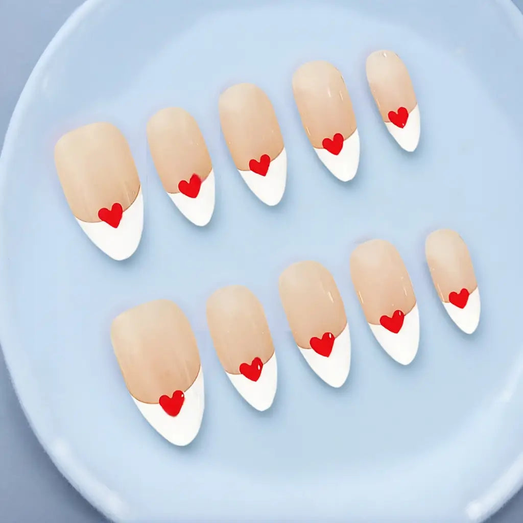 Soft nude-based Crimson Accent nail set with clean white tips reflecting elegance and brightness